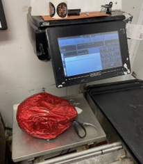 Grocery store scale weighing a ham