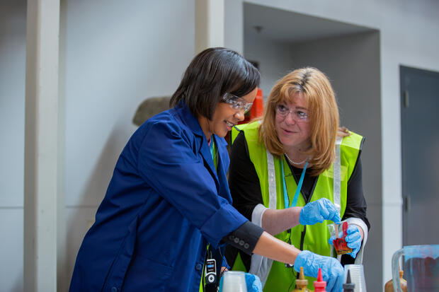 Secretary Lauren Jones and others participate in a hands-on learning activity. 