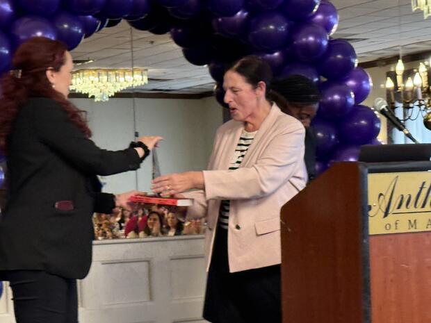Malden District Court Probation Officer Gianna Franco presents the award.