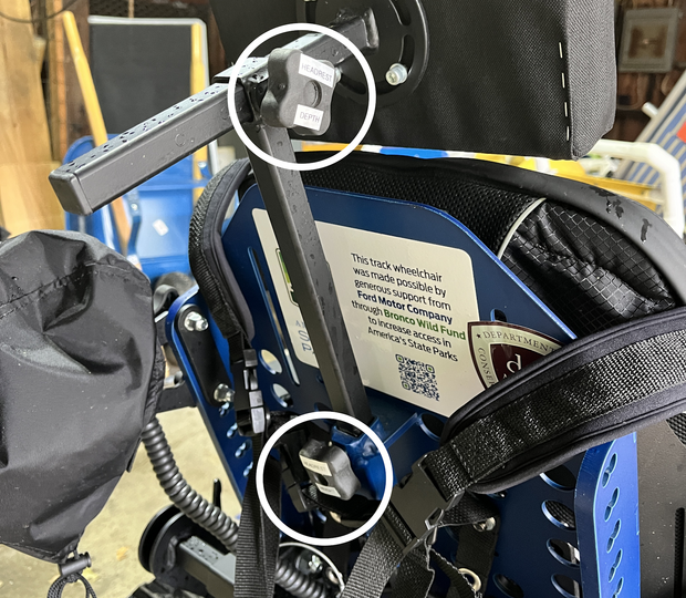 Trackchair headrest showing adjustment thumb screws.