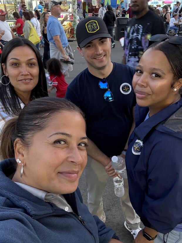 Four probation employees pose outside at the Big E
