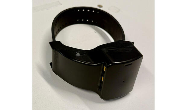 A black electronic monitoring bracelet