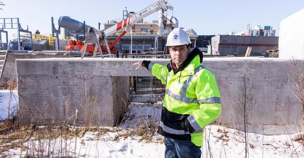 A worker shows the construction site