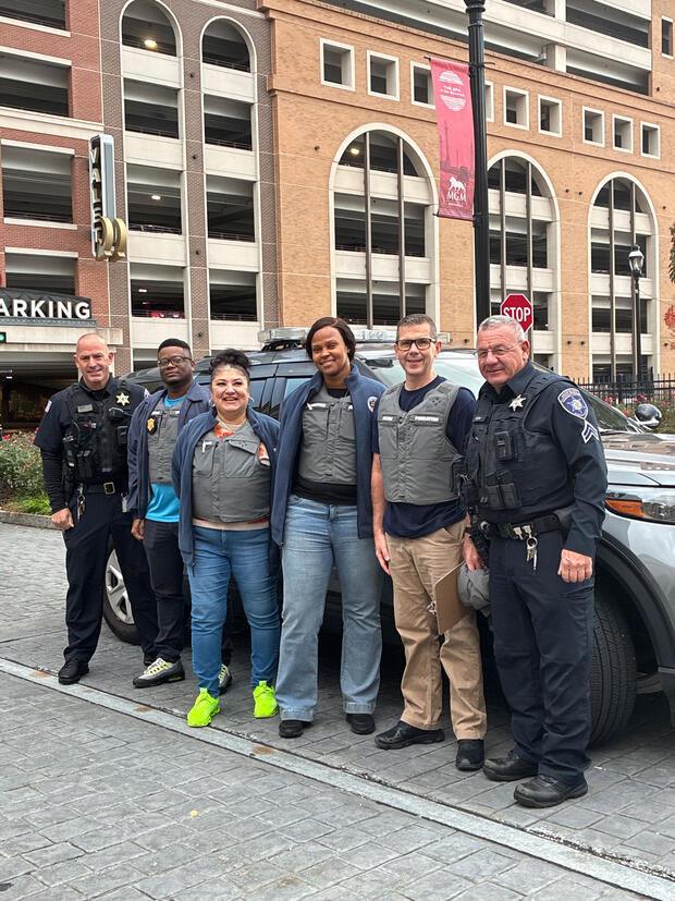 A group of six law enforcement officers standing outside.