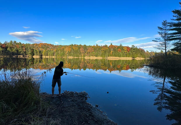 fishing in a pond in the fall
