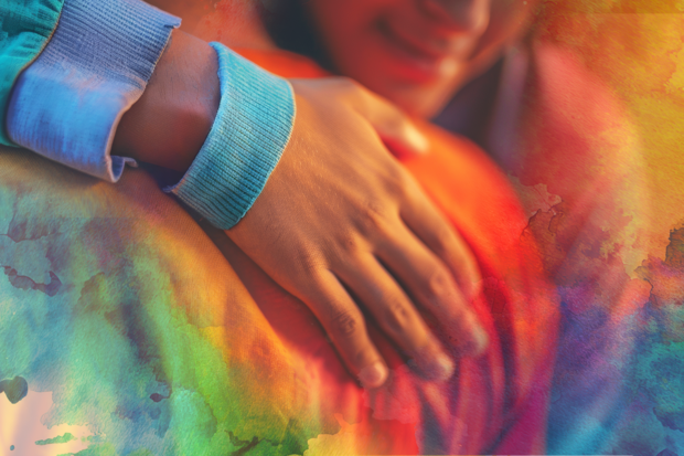 a closeup of two people hugging 