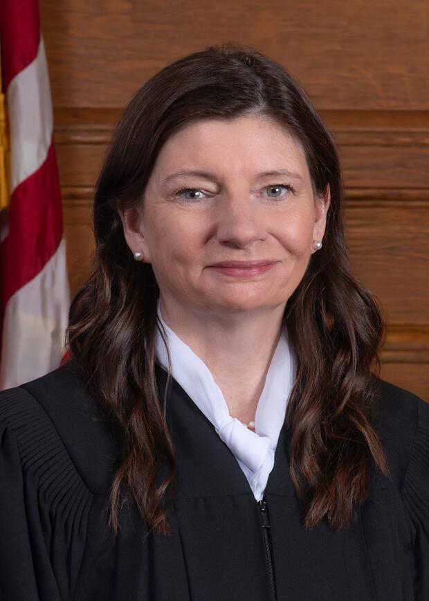 Photograph of Justice Jennifer M. Allen wearing judicial robe in courtroom.