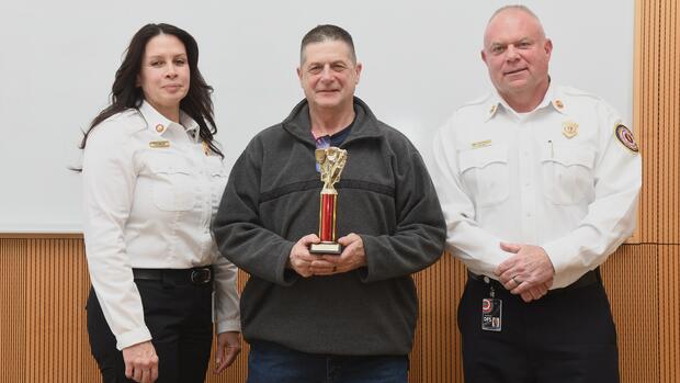 DFS staff member with a trophy