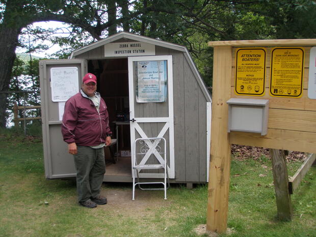 Man working at a boat ramp monitor station.