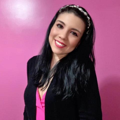 dark haired woman against pink background