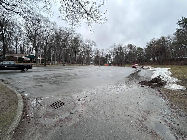 large asphalt parking lot serving the town of Wayland beach on the northern basin of Lake Cochituate