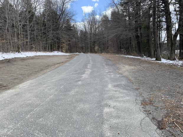 parking at enlarged gravel shoulders of access road leading to launch