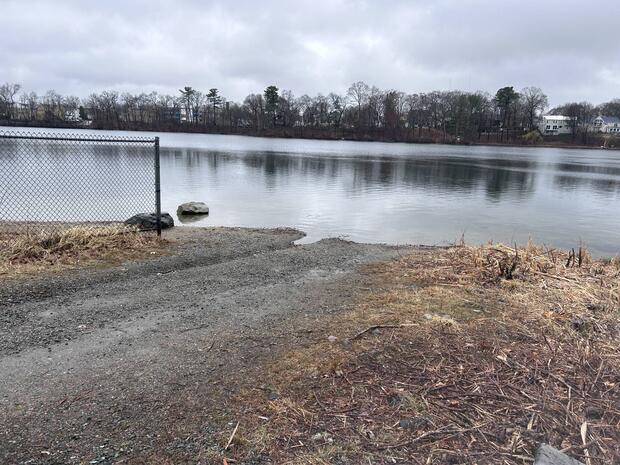 the gravel boat launch terminating into the waters of Learned Pond