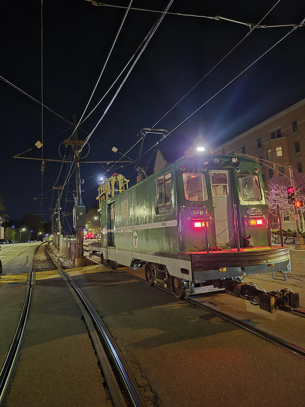The Green Line Wire Car on the tracks at night near Boston College Station.
