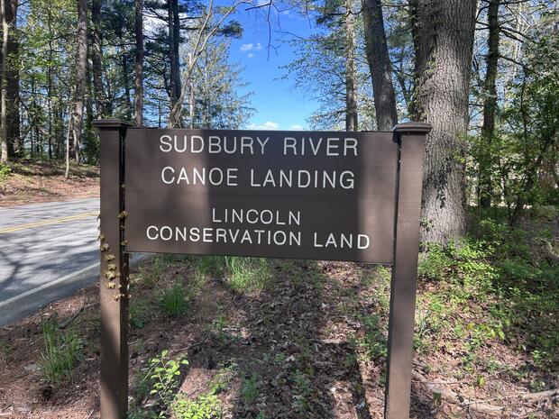 sign at side of road indicating parking area