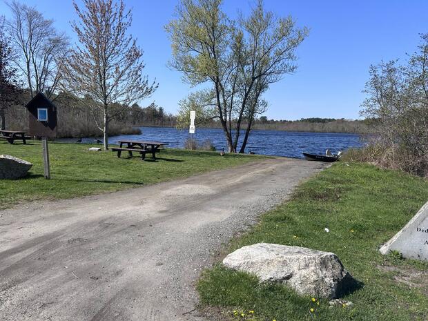 gravel boat ramp terminating at waters edge bounded by rocks on either side