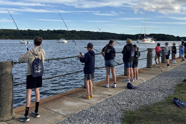 Young anglers fishing from the shore.