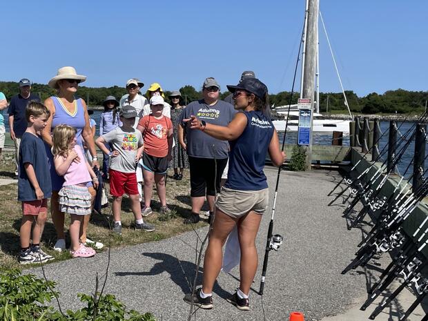 A fishing instructor speaking to a group along the Cape Cod Canal.