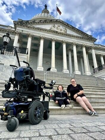 Two women sitting on the steps in Washington DC. The woman on the right is Noelle. 