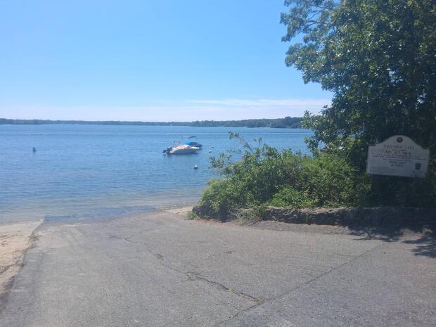 asphalt boat ramp terminating at waters edge clear skies