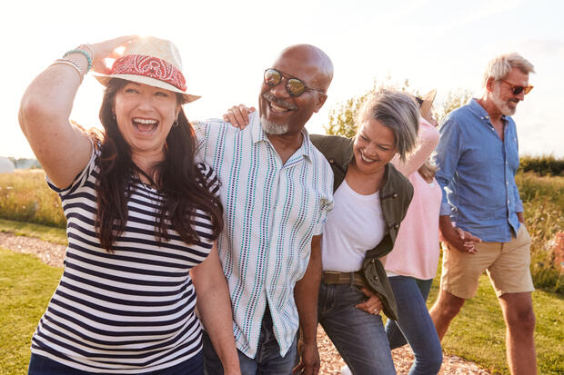 diverse group of happy adults walking outside
