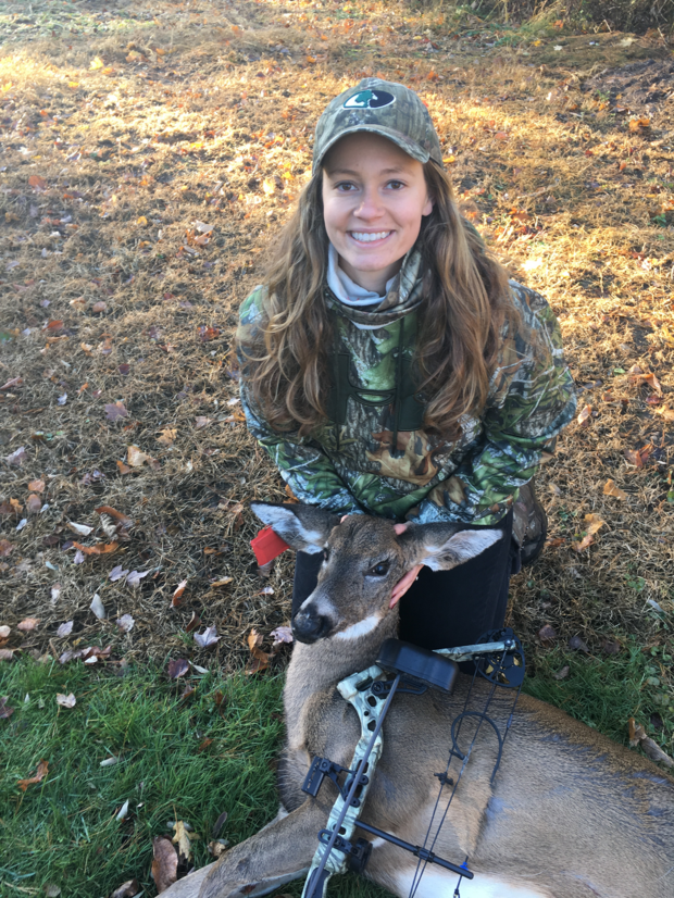 young woman poses with her harvested deer