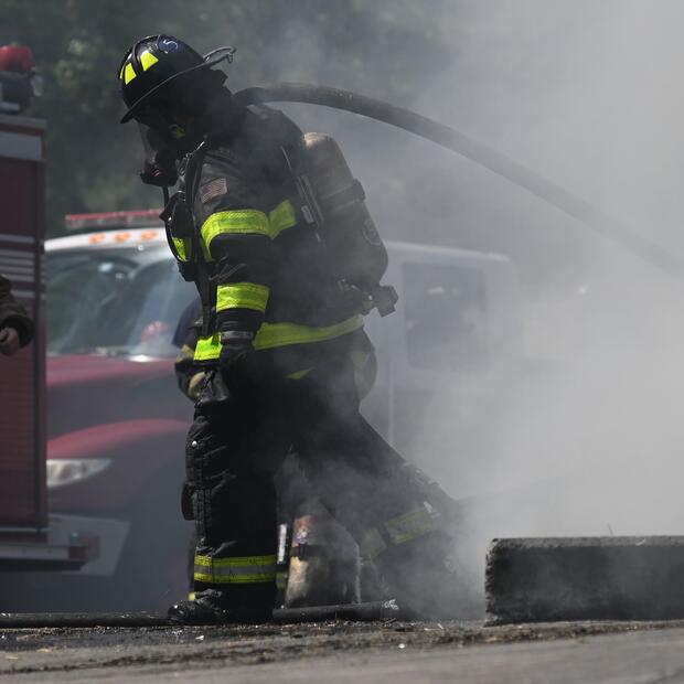 Firefighter carrying a hose