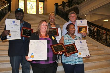 Award recipients pose on the stairs at the Statehouse