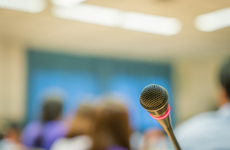 people speaking into a microphone