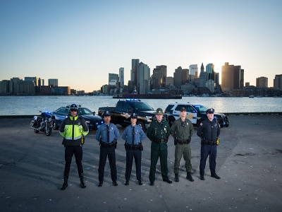 Officers standing in front of vehicles