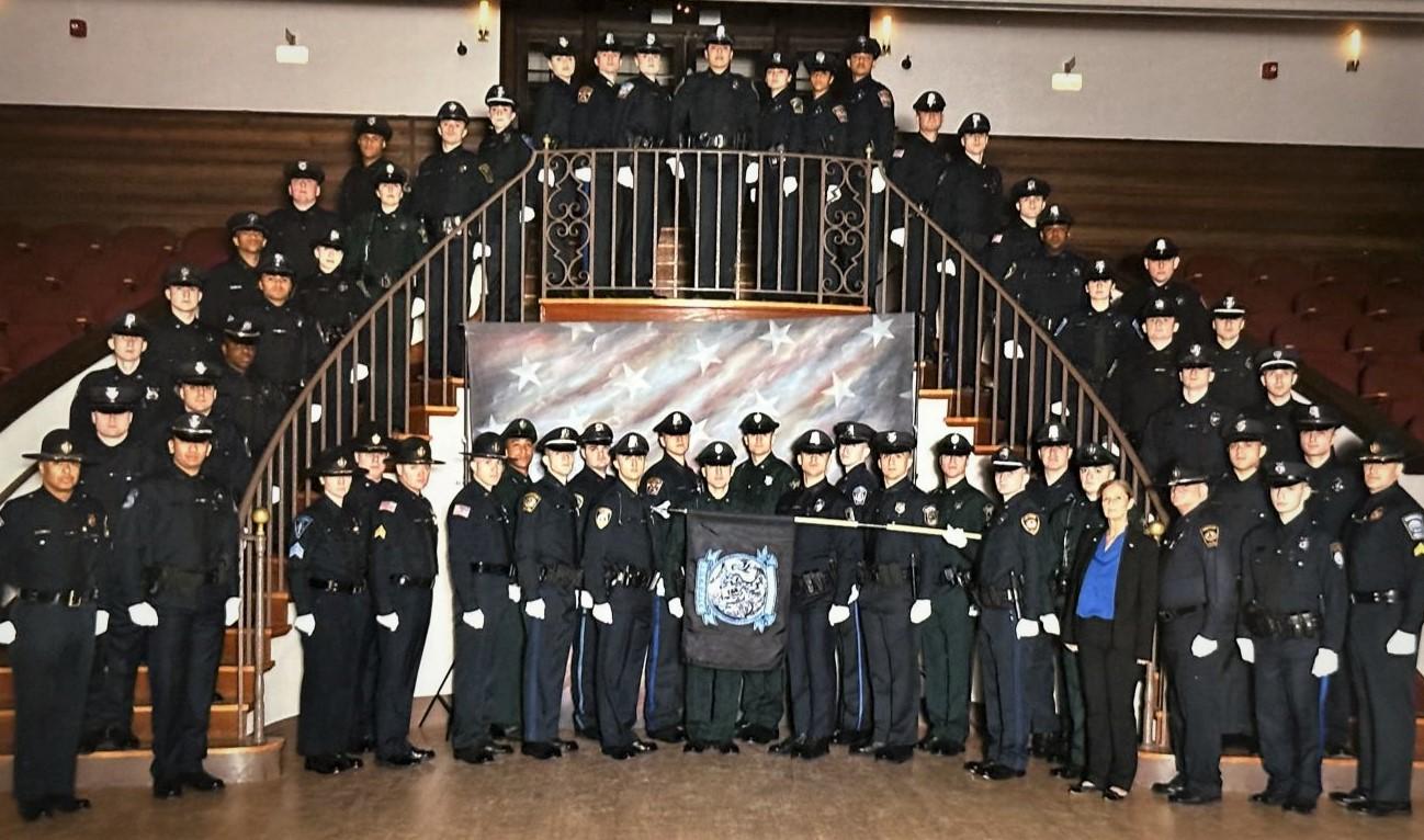 Police Officers pose for a graduation photo